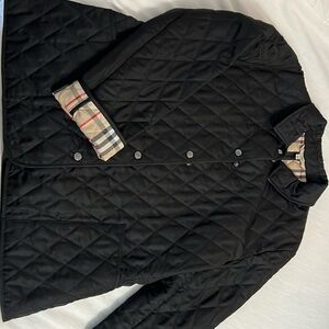 Burberry women’s black quilted jacket. Size large.